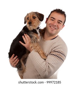 Portrait Of A Man Holding A Cute Mixed Breed Dog Isolated Over White.