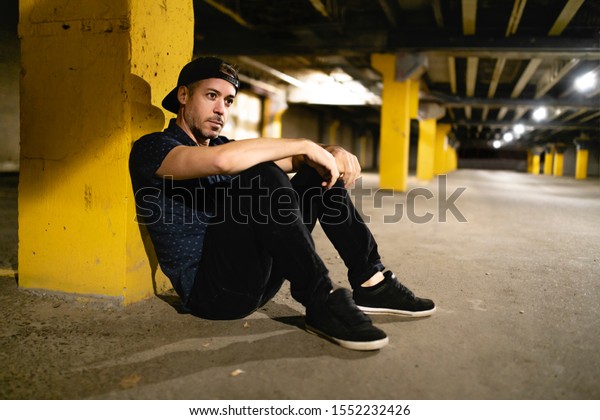 A portrait of\
a man inside basement at\
night