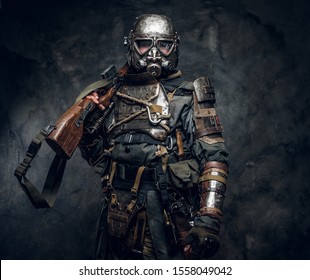 Portrait Of A Man In Interesting Costume Of Dark Apocalypse Warrior At Photo Studio.