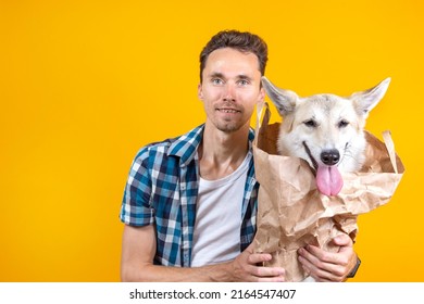 Portrait Of A Man Keeps A Dog In A Paper Grocery Bag