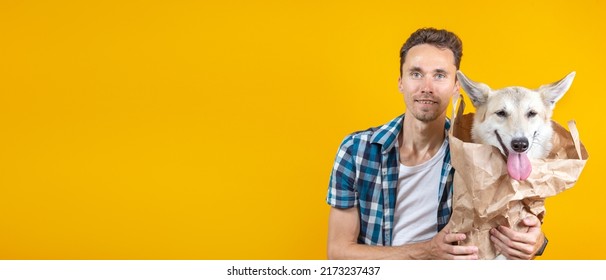 Portrait Of A Man Keeps A Dog In A Paper Grocery Bag