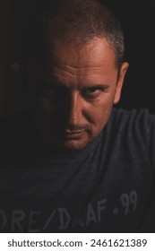 Portrait of a man looking dramatically with hidden thoughts
