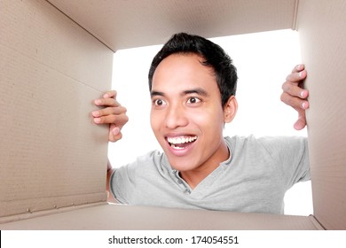 Portrait Of A Man Looking For Something Inside Box