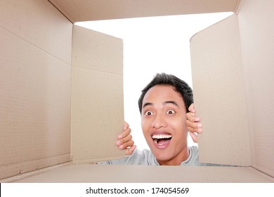 Portrait Of A Man Looking For Something Inside Box