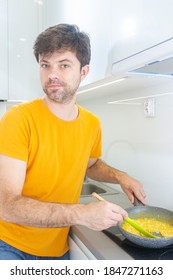 Portrait Of A Man Making Scrambled Eggs