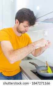 Portrait Of A Man Making Scrambled Eggs