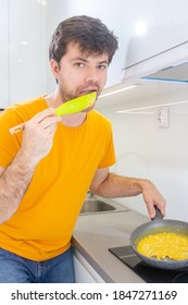 Portrait Of A Man Making Scrambled Eggs