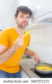 Portrait Of A Man Making Scrambled Eggs