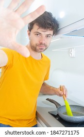 Portrait Of A Man Making Scrambled Eggs