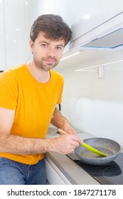 Portrait Of A Man Making Scrambled Eggs