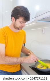 Portrait Of A Man Making Scrambled Eggs