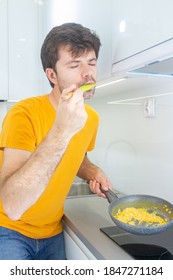 Portrait Of A Man Making Scrambled Eggs