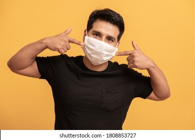 Portrait Of Man With Medical Face Mask Looking At Camera. Man Wearing Protective Mask From Virus . Coronavirus And Pandemic Concept. 