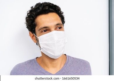 Portrait Of A Man With A Medical Facemask On White Background