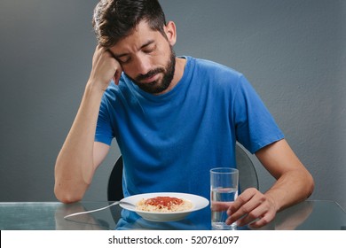 Portrait Of Man With No Appetite In Front Of The Meal. Concept Of Loss Of Appetite