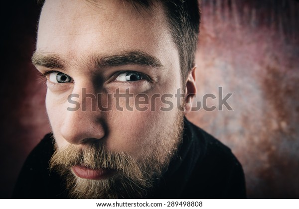 Portrait of a man peeping. funny picture. Wide-angle. Studio shot.