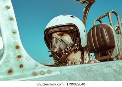 Portrait Of A Man Pilot Wearing Helmet And A Mask In Cockpit Of Fighter Jet. Military Aircraft.