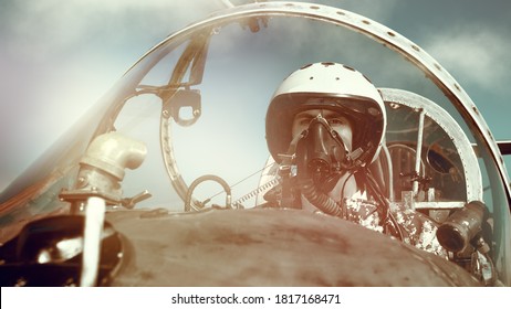 Portrait Of A Man Pilot Wearing Helmet And A Mask In Cockpit Of Fighter Jet. Military Aircraft.