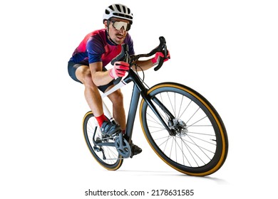 Portrait of man, professional cyclist training, riding isolated over white studio background. Concentration. Concept of sport, action, motion, speed, hobby, lifestyle. Copy space for ad