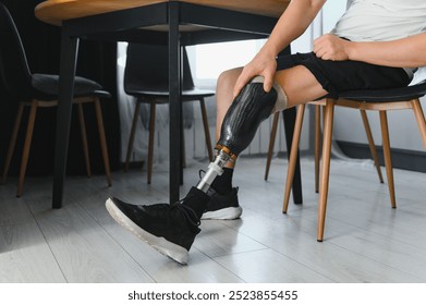 portrait of man with prosthetic leg sitting. - Powered by Shutterstock