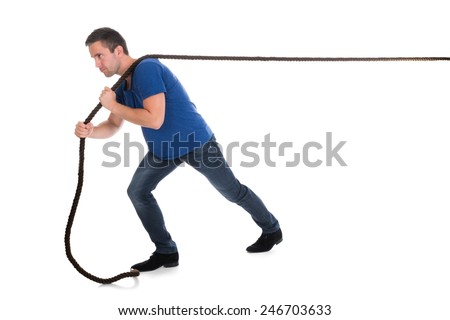 Portrait Of A Man Pulling Rope Over White Background