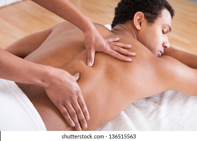 Portrait Of Man Receiving Massage Treatment From Female Hand