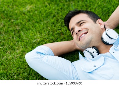 Portrait Of A Man Relaxing Outdoors With Headphones 