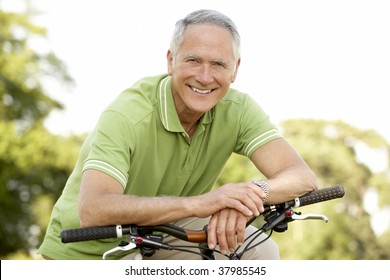 Portrait of man riding cycle in countryside - Powered by Shutterstock