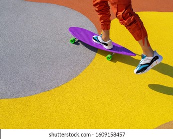 Portrait of a man riding a longboard on the cityscape background. Longboarding in the city. Extreme sport, leisure activity, hobby and motion concept.