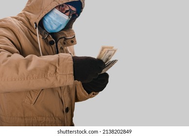 Portrait Of Man In Safety Medical Mask Holding Big Cash Money Pack, Elderly People During A Pandemic