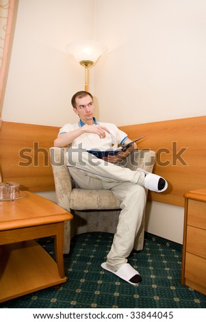 portrait of the man sitting in a chair