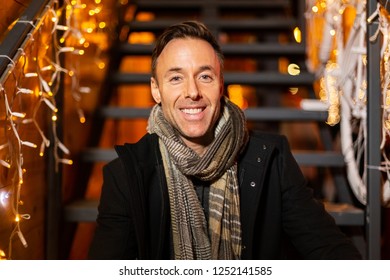 Portrait of man sitting on stairs at Christmas market, Zagreb, Croatia. - Powered by Shutterstock