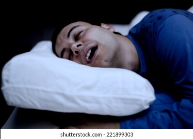 Portrait Of A Man Sleeping Soundly In His Bedroom