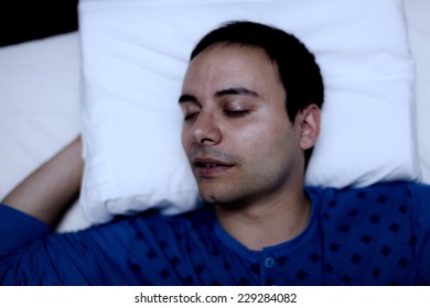 Portrait Of A Man Sleeping Soundly In His Bedroom