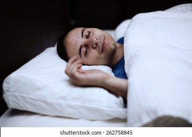 Portrait Of A Man Sleeping Soundly In His Bedroom