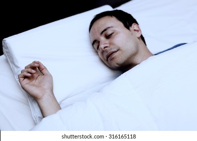 Portrait Of A Man Sleeping Soundly In His Bedroom