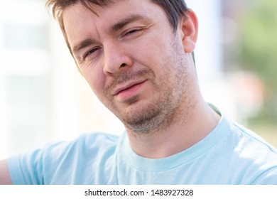 Portrait of man. Man squints in the sun