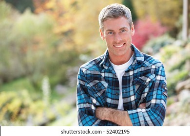 Portrait Of Man Standing Outside In Autumn Landscape