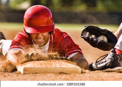 Portrait of man stealing base in baseball