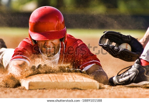 Portrait of man stealing\
base in baseball