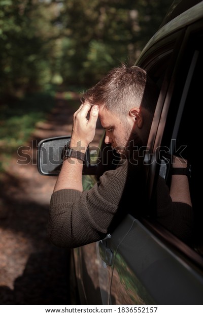 portrait of a man stick
out of car window