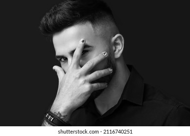 Portrait Of Man With Stylish Manicure Closing His Face With Hand On Dark Background