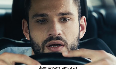 Portrait Of Man With Sweat On Forehead Driving Car In Hot Summer Day