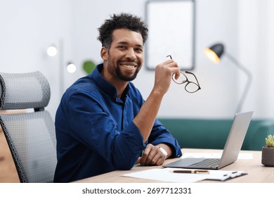 Portrait of man at table in office