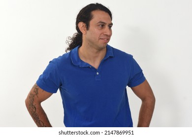 Portrait Of A Man With Tatoo On Amrs Looking Away On White Background