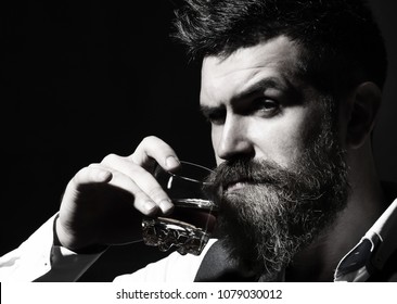 Portrait Of Man With Thick Beard. Macho Drinking. Stylish Rich Man Holding A Glass Of Old Whisky. Bearded Gentleman Drink Cognac. Sipping Finest Whiskey. Black And White.