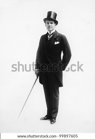 Portrait of a man in a top hat and morning suit holding a cane