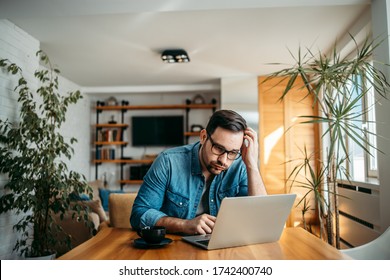 Portrait of a man with troubled face looking at laptop at home office. - Shutterstock ID 1742400740