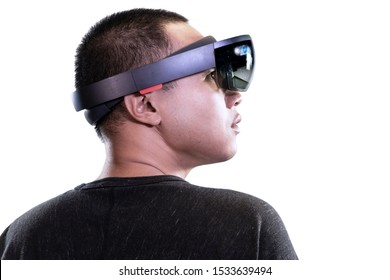 Portrait Of Man Try Mixed Reality With HoloLens Glasses Isolated On White Background. Future Technology Concept.