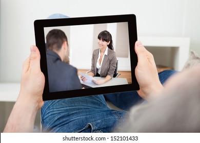 Portrait Of A Man Watching Movie On Tablet Indoors